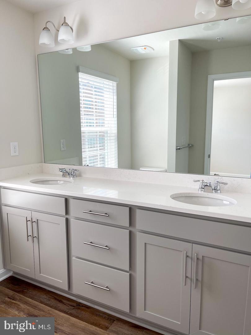7066 Delegate Place Frederick, MD 21703 - Photo 18 of 25 a bathroom with a sink and a mirror