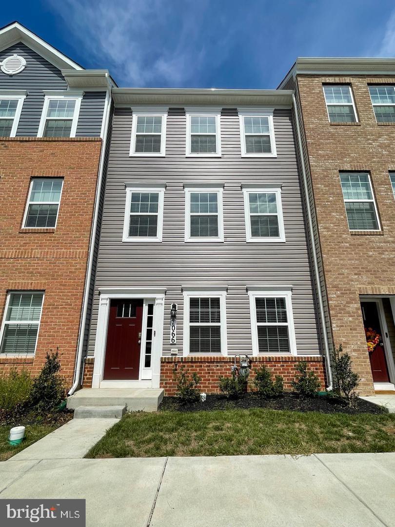 7066 Delegate Place Frederick, MD 21703 - Photo 2 of 25 a front view of a house with a yard