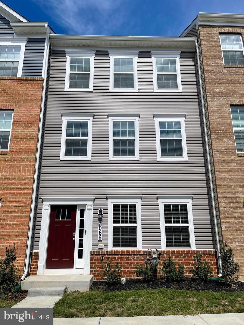 7066 Delegate Place Frederick, MD 21703 - Photo 2 of 25 a brick house that has a small yard