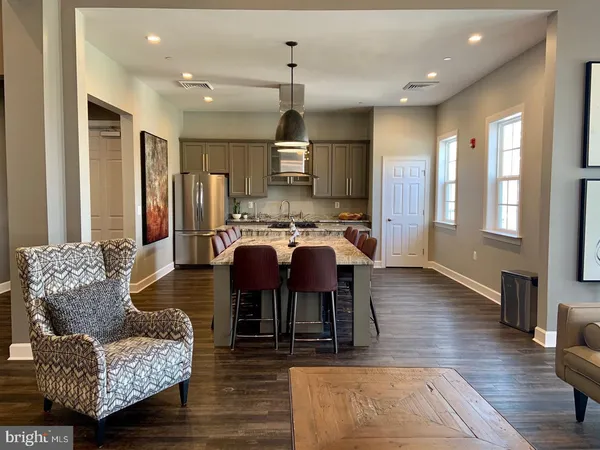 a living room with furniture and a large mirror