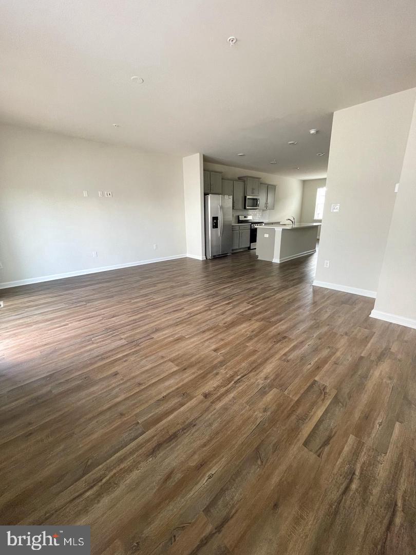 7066 Delegate Place Frederick, MD 21703 - Photo 6 of 25 a view of empty room with wooden floor