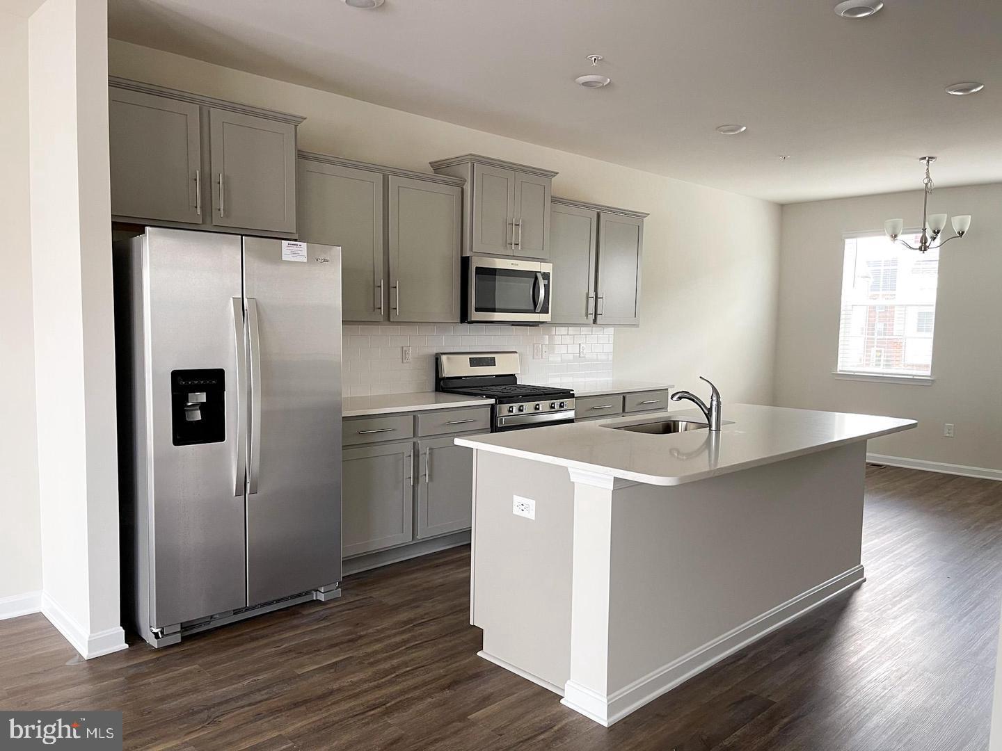 7066 Delegate Place Frederick, MD 21703 - Photo 9 of 25 a kitchen with stainless steel appliances a refrigerator sink and microwave