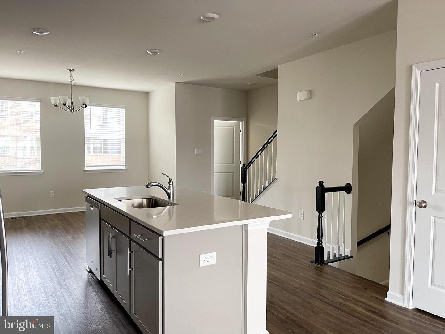 7066 Delegate Place Frederick, MD 21703 - Photo 10 of 25 a kitchen with stainless steel appliances granite countertop a sink stove and wooden floor