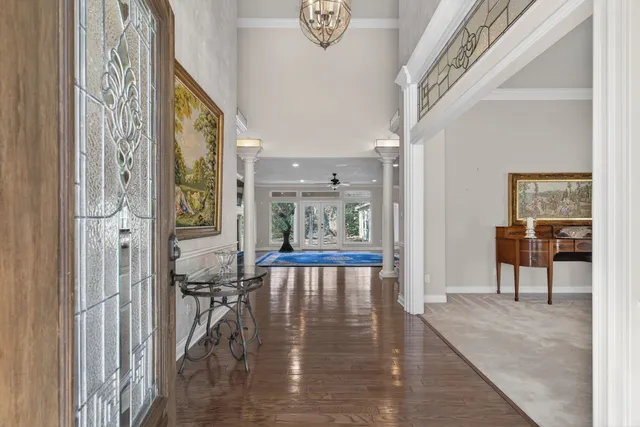 a view of an entryway with wooden floor and a livingroom view