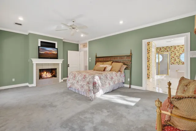 a large white bathroom with a sink a large mirror and shower