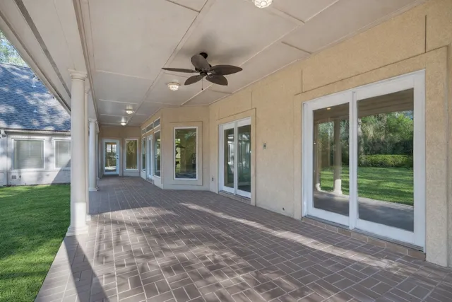 a view of a porch with furniture and garden