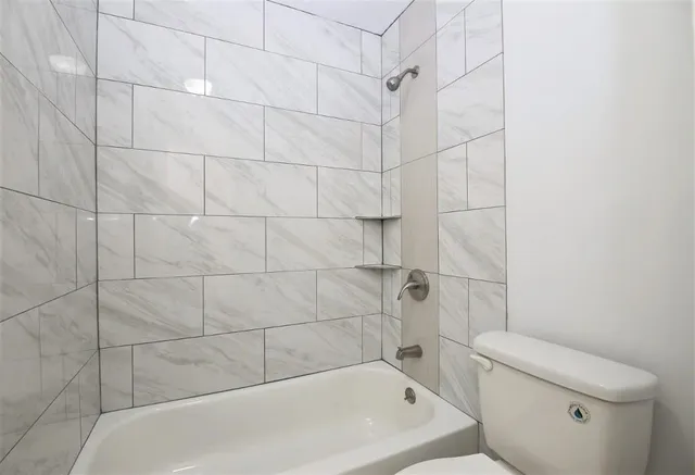a bathroom with a bathtub and toilet