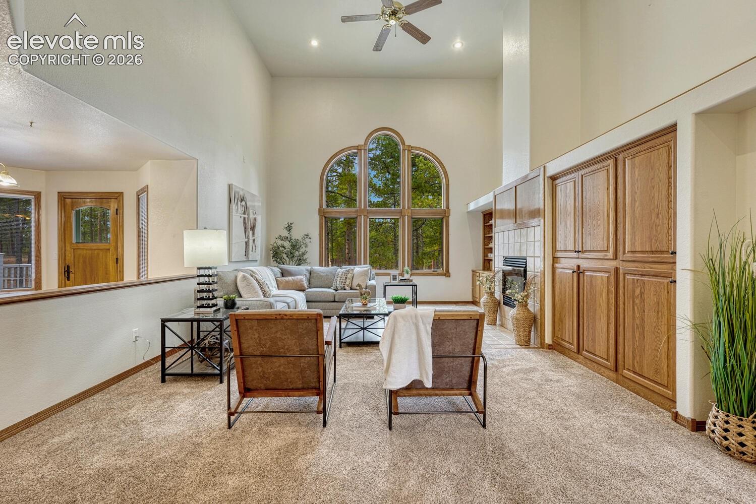 15430 Bar X Road Colorado Springs, CO 80908 - Photo 12 of 50 The inviting Family Room has high ceilings, a lighted ceiling fan, and plush neutral carpet.