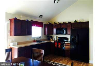 28 Job Road Inwood, WV 25428 - Photo 4 of 15 a kitchen with granite countertop a refrigerator a stove a sink and dishwasher with wooden floor