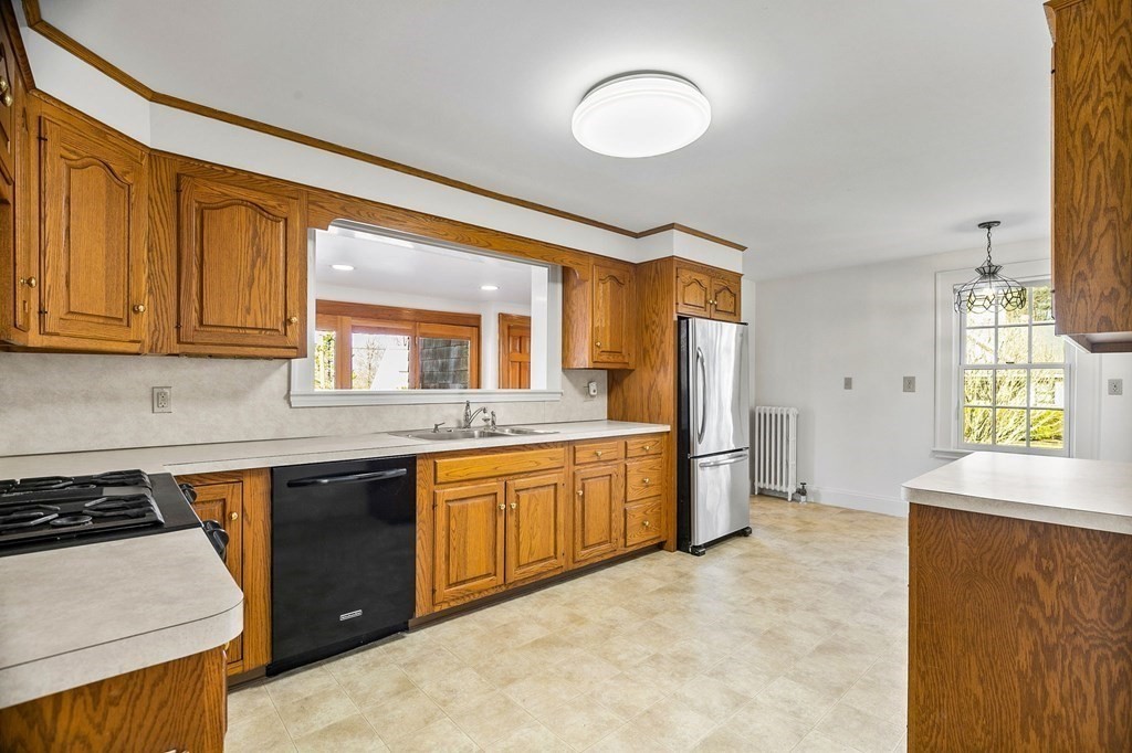 8 Parker Road Winchester, MA 01890 - Photo 16 of 37 a kitchen with stainless steel appliances granite countertop a stove a sink and a refrigerator