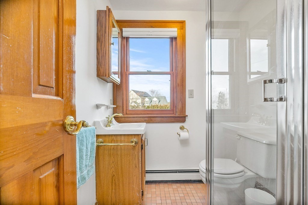 8 Parker Road Winchester, MA 01890 - Photo 17 of 37 a bathroom with a granite countertop toilet a sink a mirror and shower