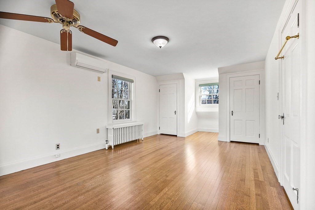 8 Parker Road Winchester, MA 01890 - Photo 20 of 37 an empty room with wooden floor cabinet and windows