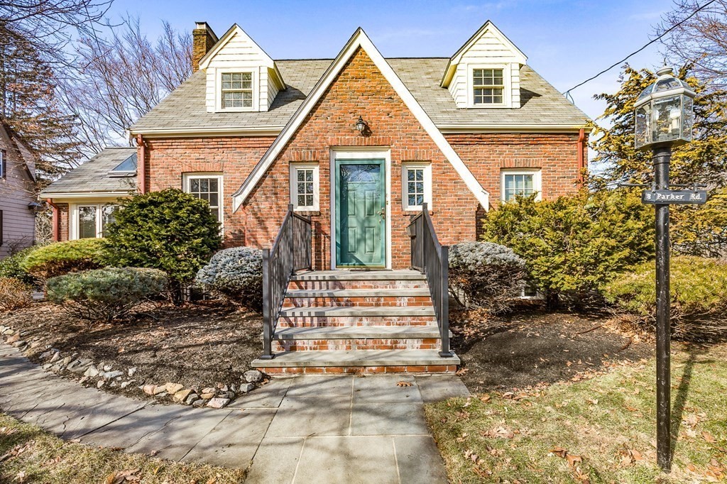 8 Parker Road Winchester, MA 01890 - Photo 2 of 37 a view of a brick house with many windows next to a yard
