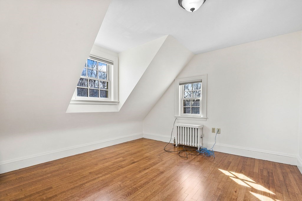 8 Parker Road Winchester, MA 01890 - Photo 24 of 37 an empty room with wooden floor and windows