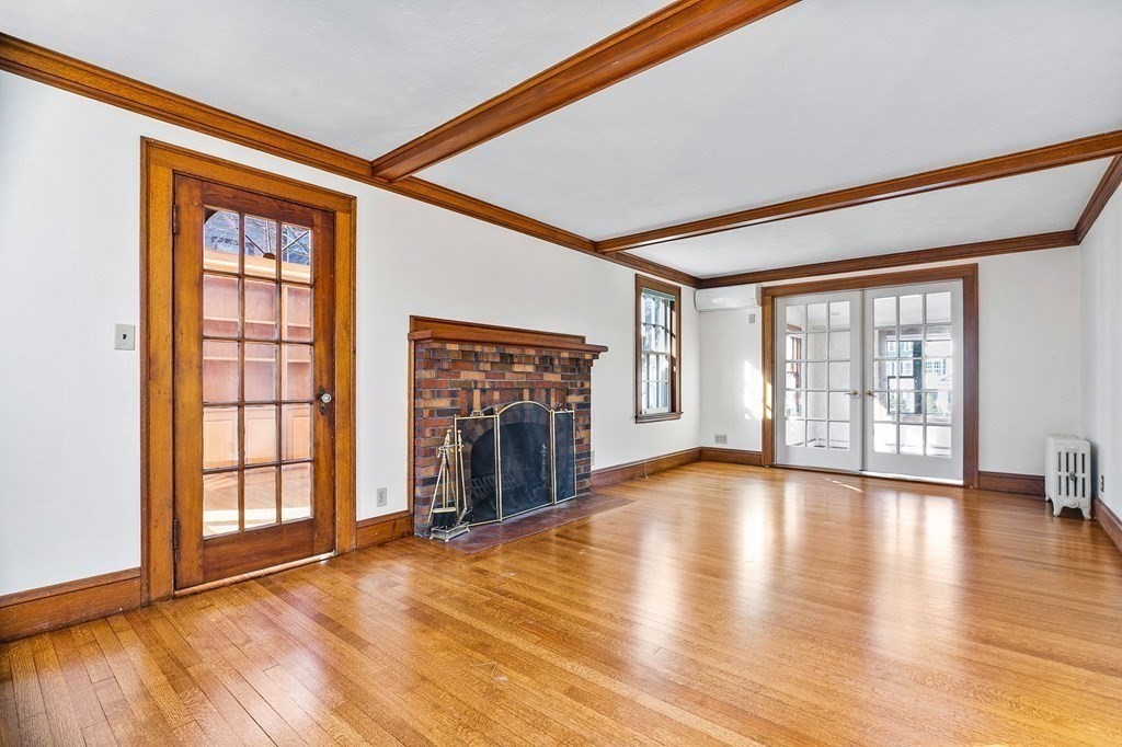 8 Parker Road Winchester, MA 01890 - Photo 8 of 37 a view of an empty room with window and wooden floor