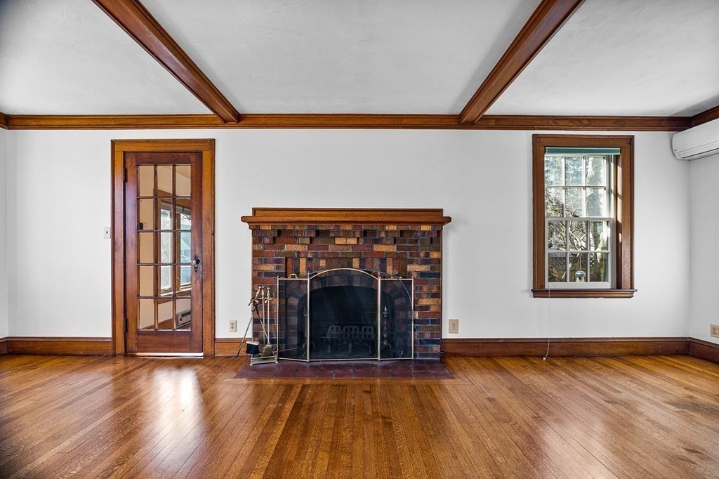 8 Parker Road Winchester, MA 01890 - Photo 9 of 37 an empty room with wooden floor fireplace and windows