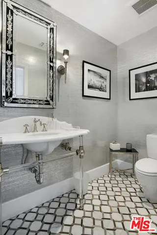 a large bathroom with a granite countertop sink a large mirror a shower and a bathtub