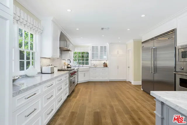 a living room with fireplace furniture and a wooden floor