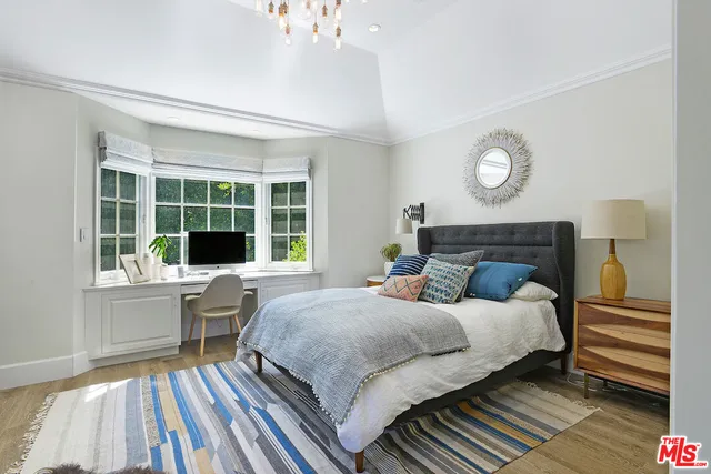 a living room with furniture a rug and white walls
