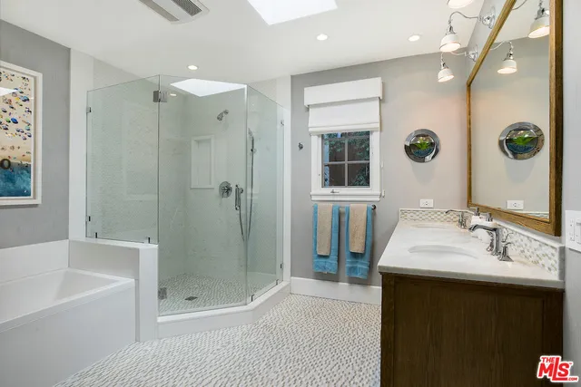 a bathroom with a sink double vanity and shower