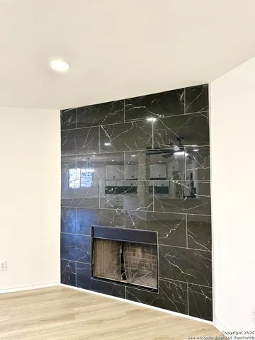 a kitchen with stainless steel appliances kitchen island granite countertop a refrigerator oven a sink a stove a dining table and chairs