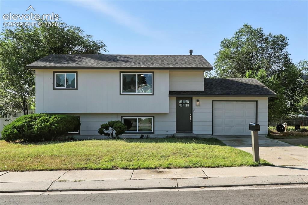 7033 Sequoyah Way Colorado Springs, CO 80915 - Photo 1 of 20 a house view with a garden space