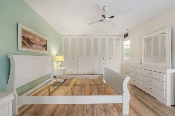 a bathroom with a sink a toilet a mirror and shower