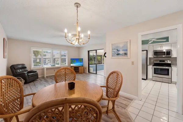 a view of a dining room with furniture and chandelier