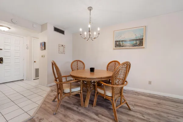 a view of a dining room with furniture and chandelier