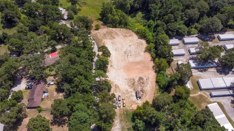 an aerial view of a house with a yard and garden
