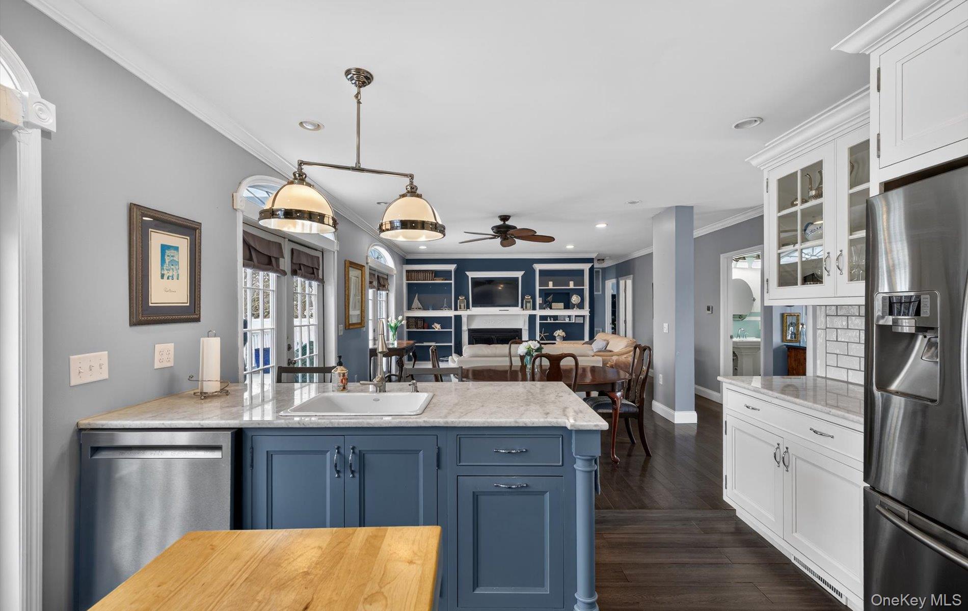 108 Awixa Avenue Bay Shore, NY 11706 - Photo 47 of 47 Dual tone kitchen featuring a peninsula, stainless steel appliances, open floor plan, ornamental molding, and light stone countertops
