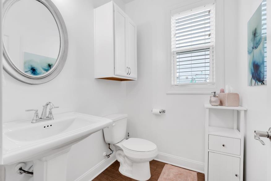 205 Lakeside Place Canton, GA 30114 - Photo 18 of 65 a bathroom with a toilet a sink and a mirror