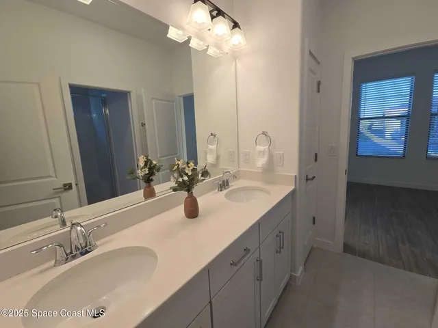 a bathroom with a sink vanity and a mirror