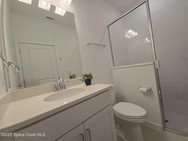 a bathroom with a sink a toilet and mirror