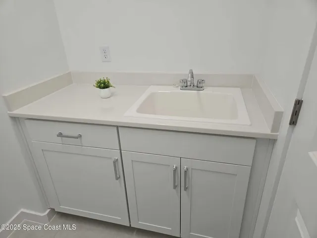 a bathroom with a sink and cabinets