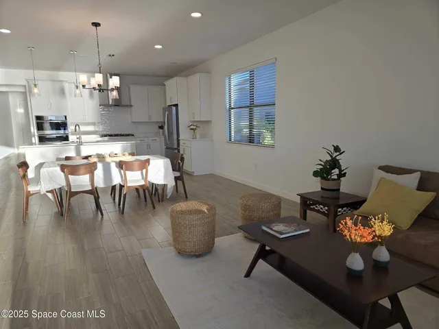 a dining room with furniture and a chandelier