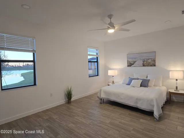 a bedroom with a bed and a large mirror