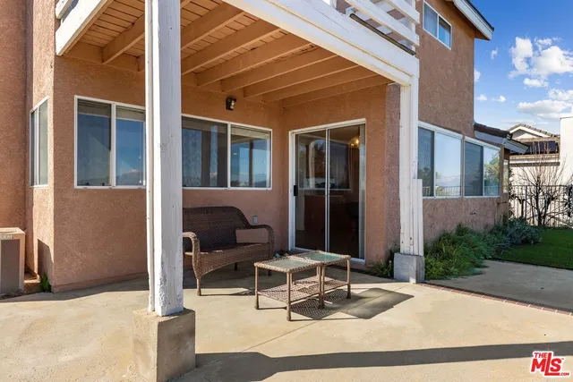 a building outdoor space with patio furniture and potted plants