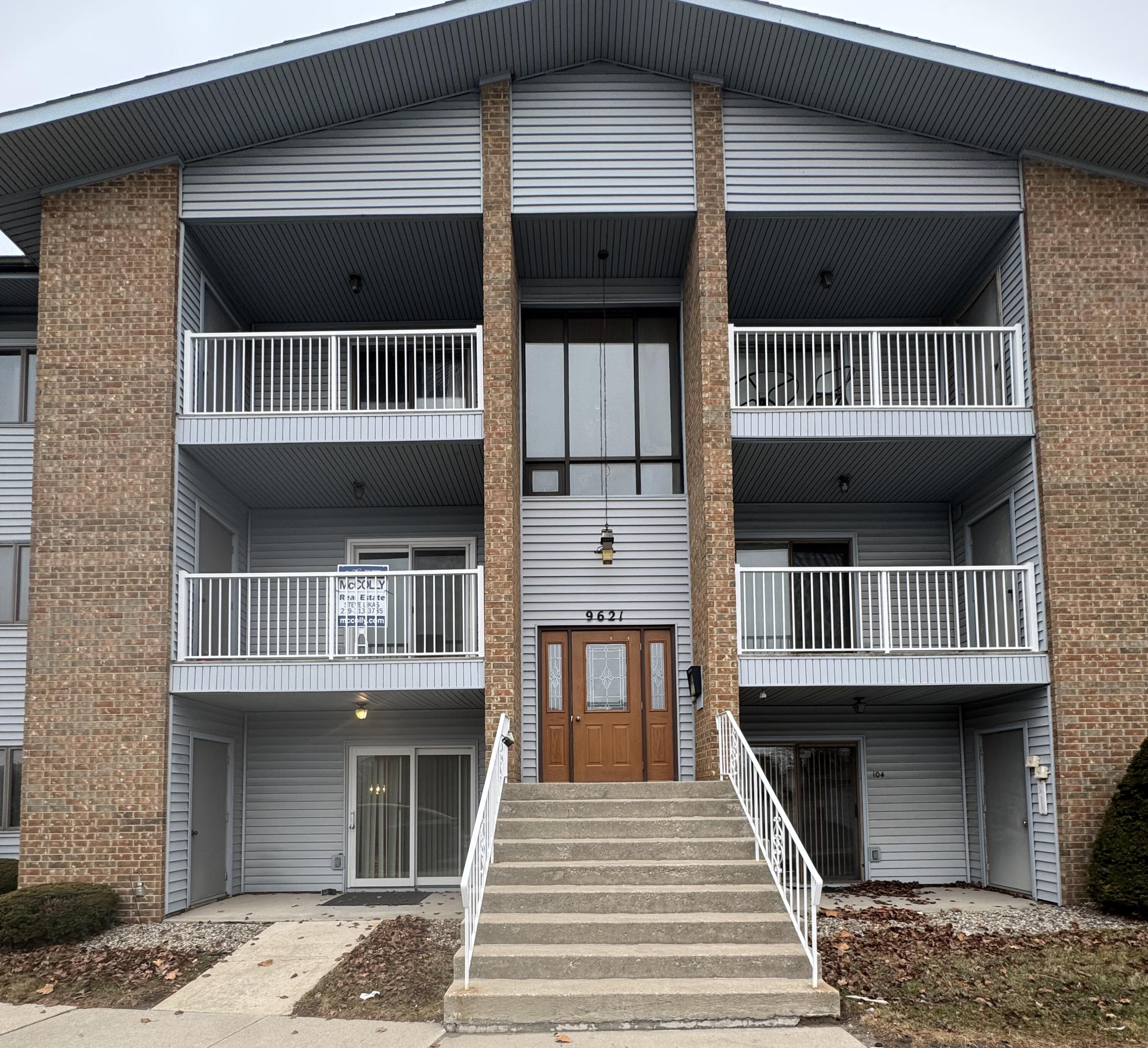 9621 Merrillville Road, Unit 103 Crown Point, IN 46307 - Photo 1 of 5 a front view of a house with a balcony
