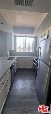 a kitchen with sink cabinets and appliances