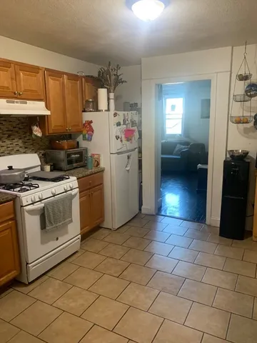 a kitchen with a stove a sink and a refrigerator