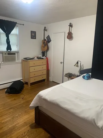 a bedroom with a bed and a dresser