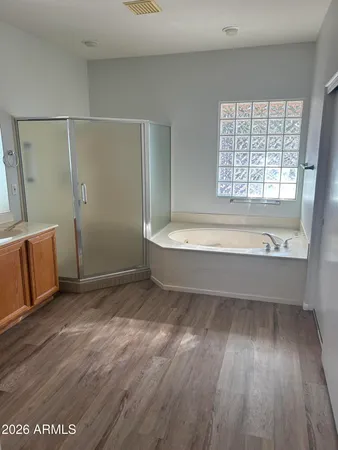 a bathroom with a bathtub and a shower