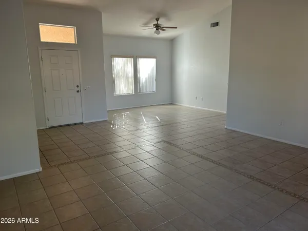 an empty room with windows and closet