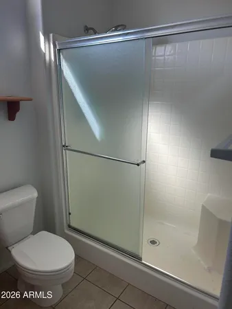 a bathroom with a toilet and a shower