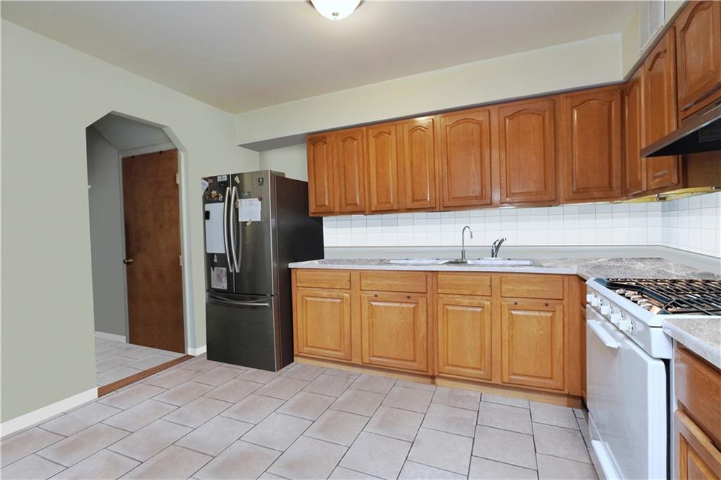 4 Ave Y Brooklyn, NY 11214 - Photo 13 of 25 a kitchen with stainless steel appliances granite countertop a refrigerator sink and cabinets