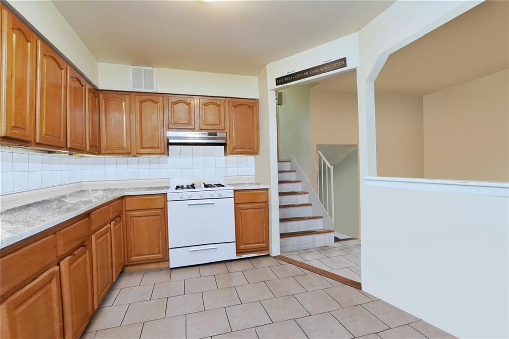 4 Ave Y Brooklyn, NY 11214 - Photo 14 of 25 a kitchen with a stove top oven and cabinets