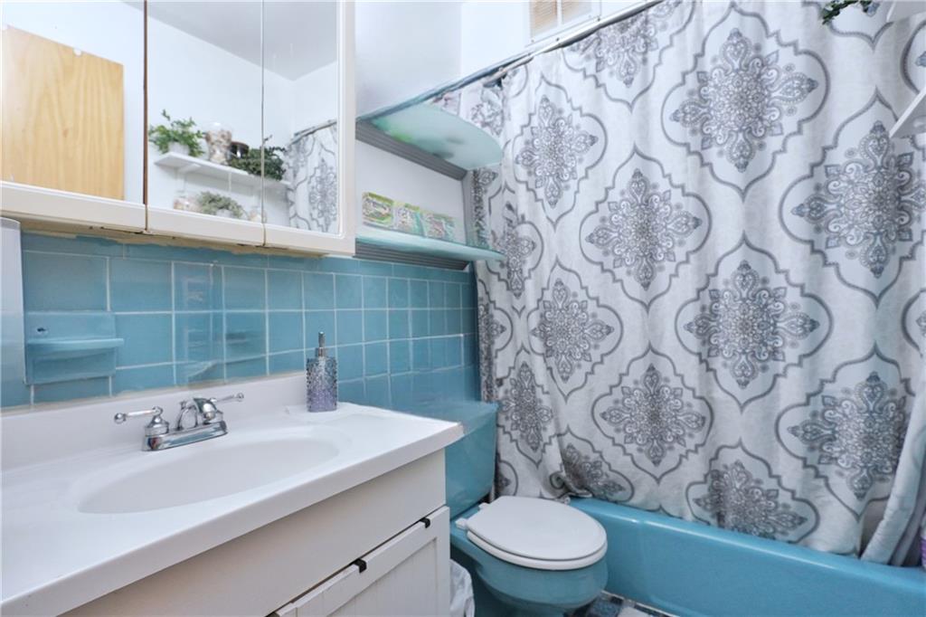 4 Ave Y Brooklyn, NY 11214 - Photo 15 of 25 a bathroom with a sink and a toilet