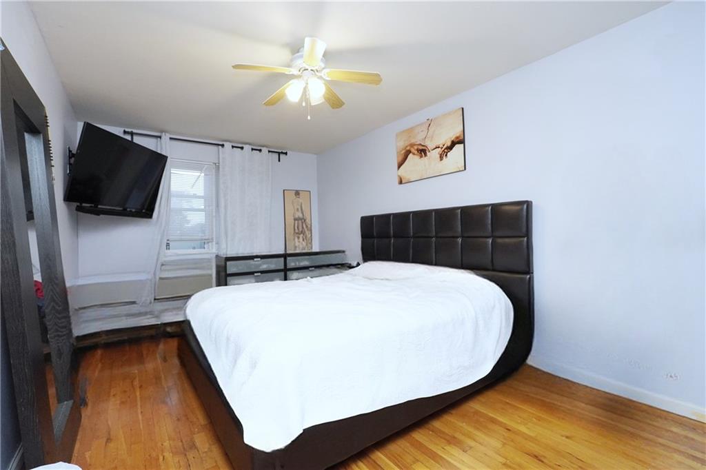 4 Ave Y Brooklyn, NY 11214 - Photo 16 of 25 a bedroom with a bed and a flat screen tv