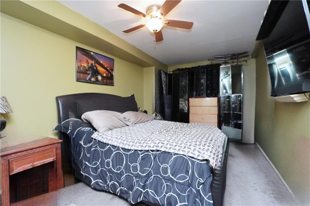 4 Ave Y Brooklyn, NY 11214 - Photo 9 of 25 a bedroom with a bed and a chandelier